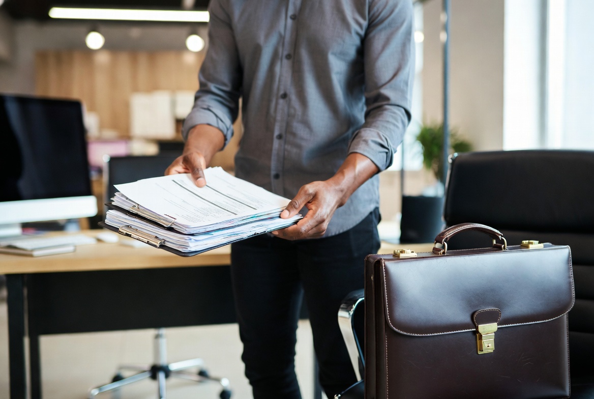 A financial professional holding documents in a bright CPA office